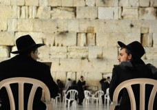 Two-Jewish-men-in-chairs-near-the-Western-Wall
